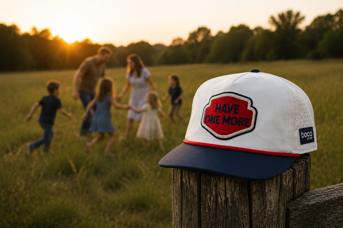 Have One More hat on a fence post with a family playing in a field at sunset