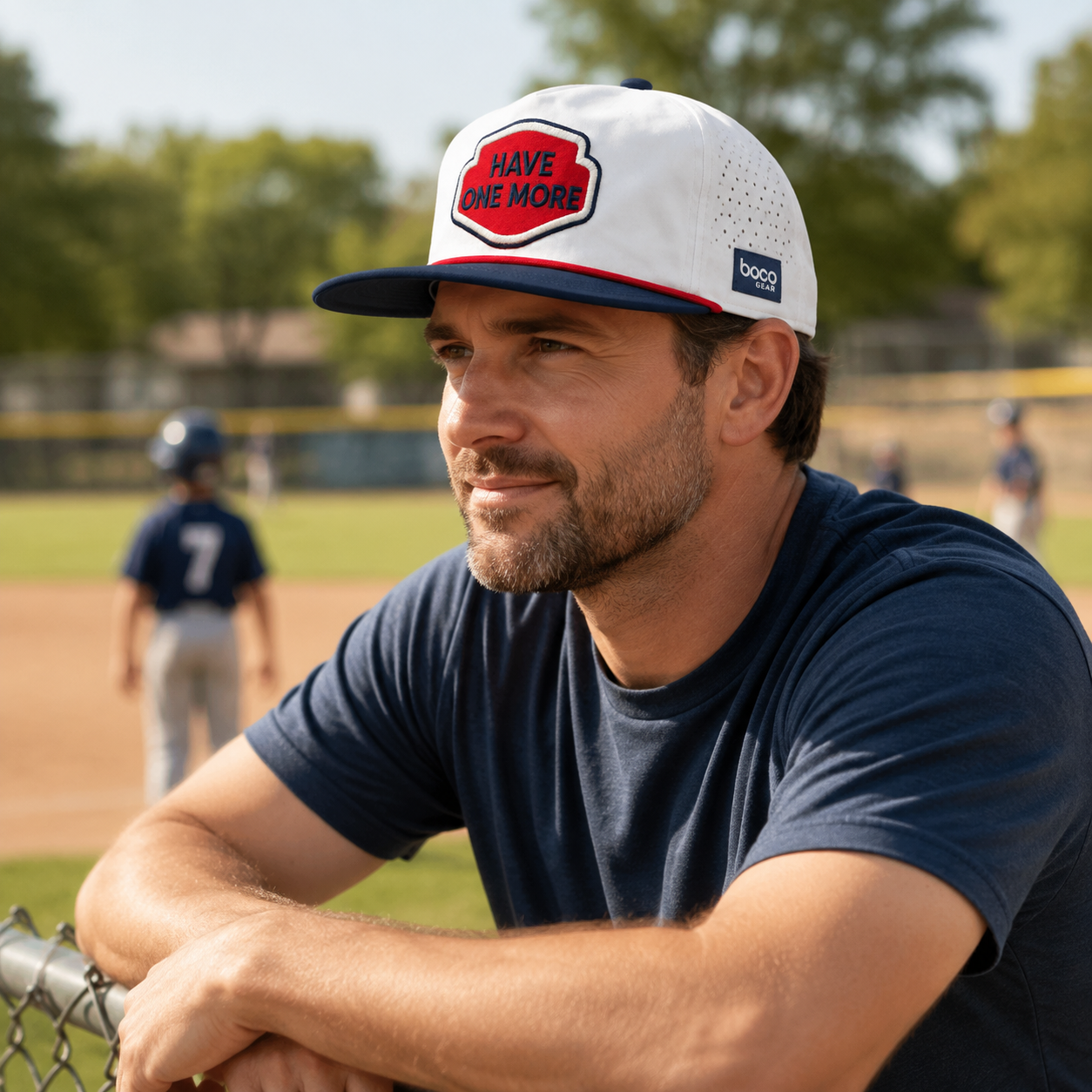 Father wearing the Have One More BOCO Lowdown Trucker Hat at a youth baseball field